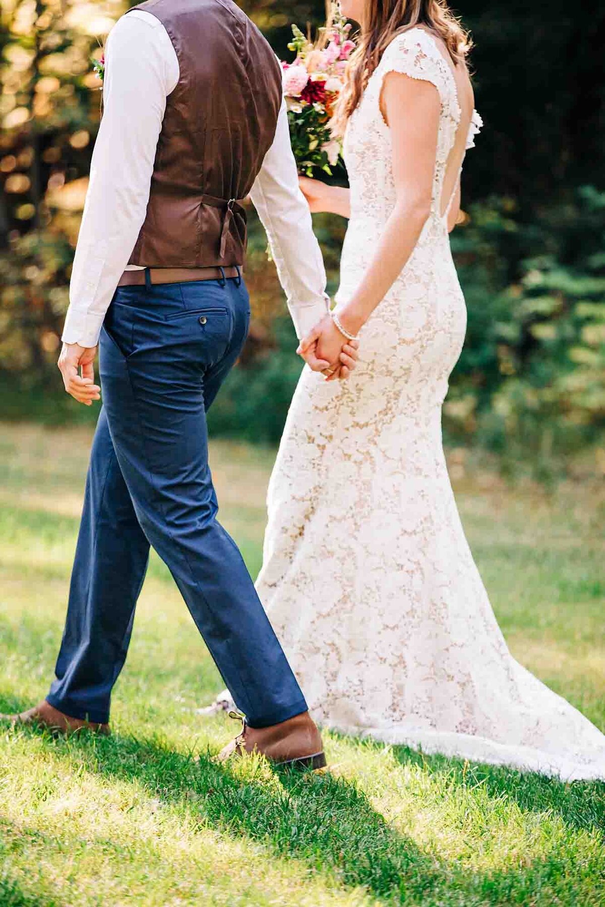 Bride and groom walking hand in hand, Izaak Walton Inn, Essex