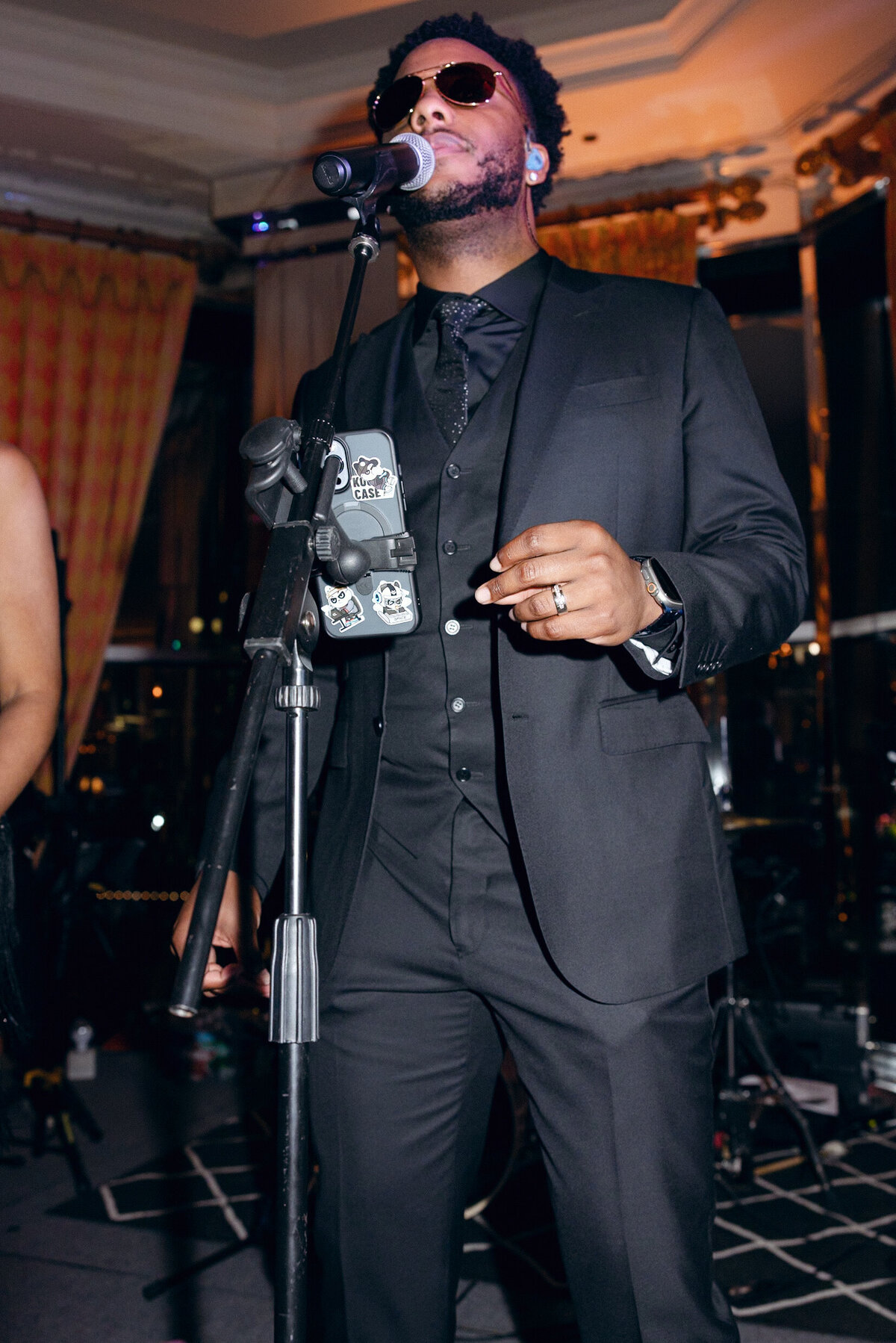 A wedding day photo of the singer of the band singing during the wedding reception