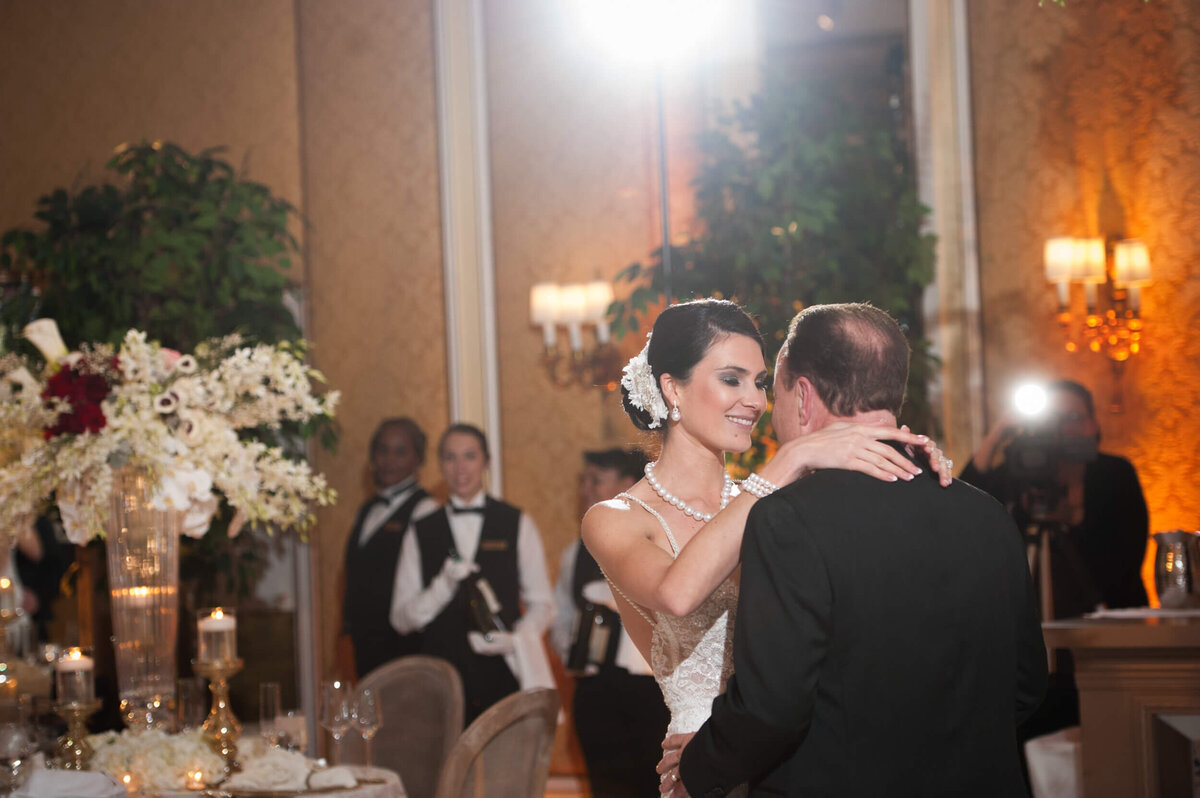 Bride gazes into her husband's eyes while they dance happily at their reception