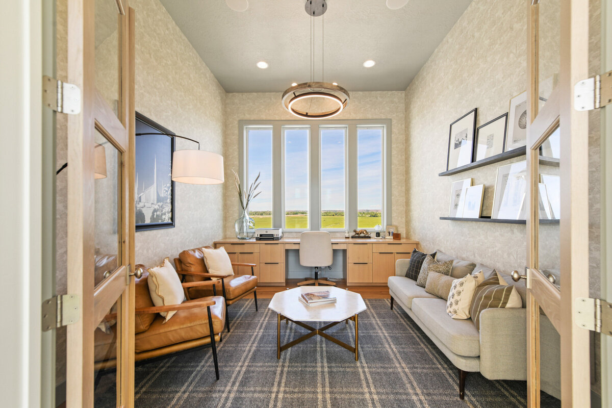 Custom office design with statement lighting and built in cabinets with a beautiful view by Idaho luxury custom home builder Thompson Homes
