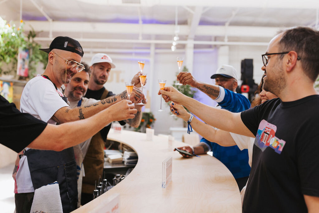 Guests clink glasses in celebration in front of the Absolut bar.
