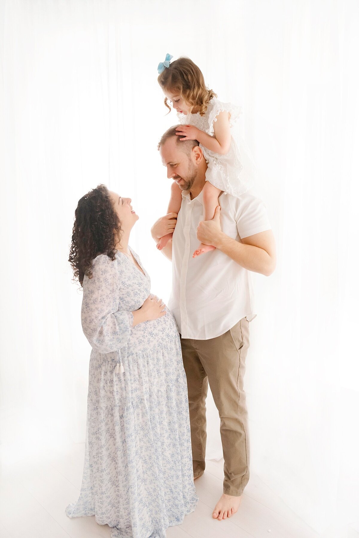 family smiling at each other taken by boston area family photographer​