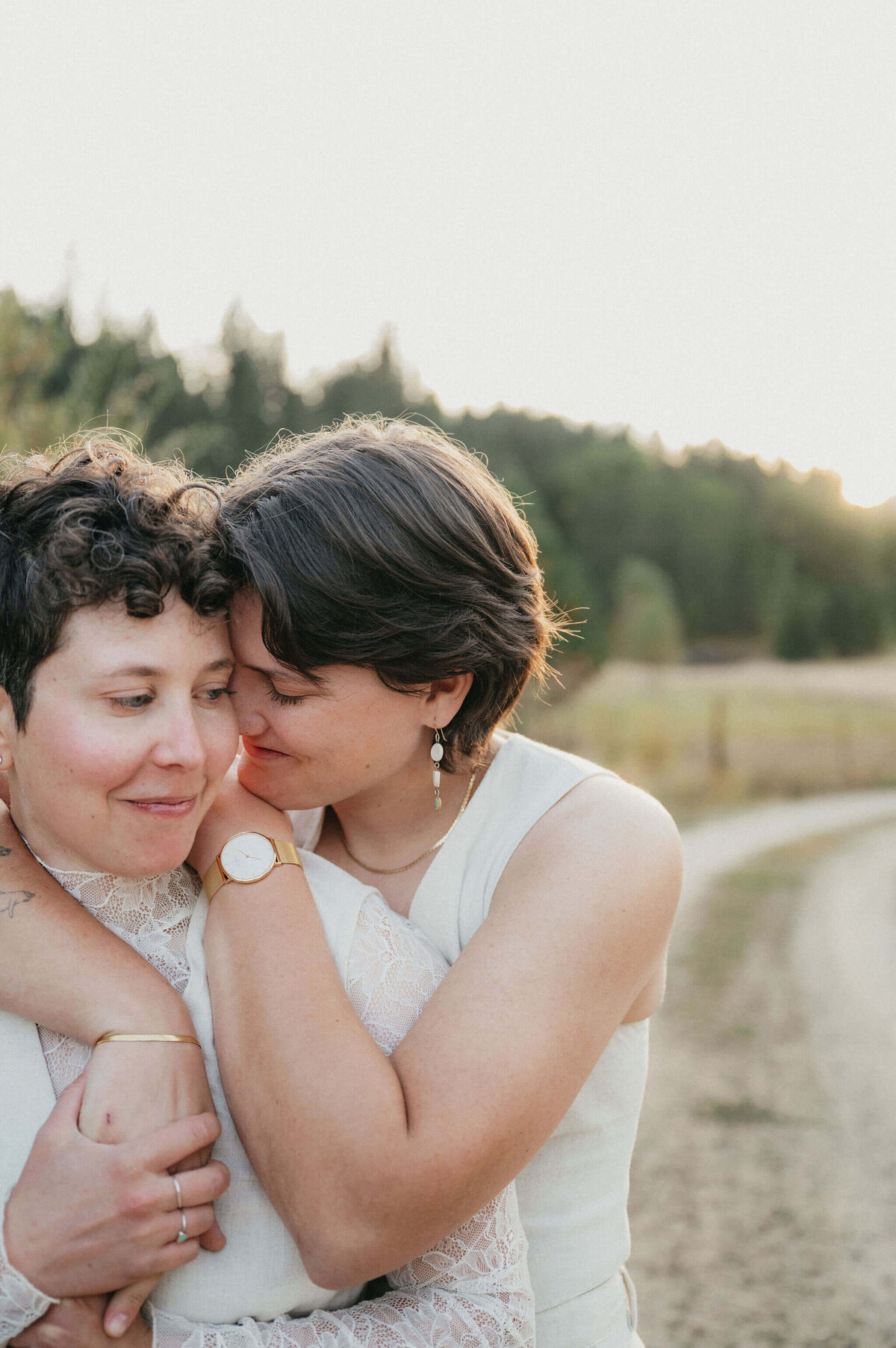 Wedding couple embracing on a dirt road