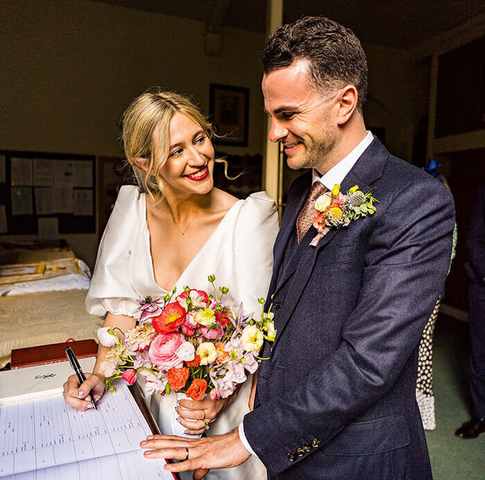 Bride and groom signing 272