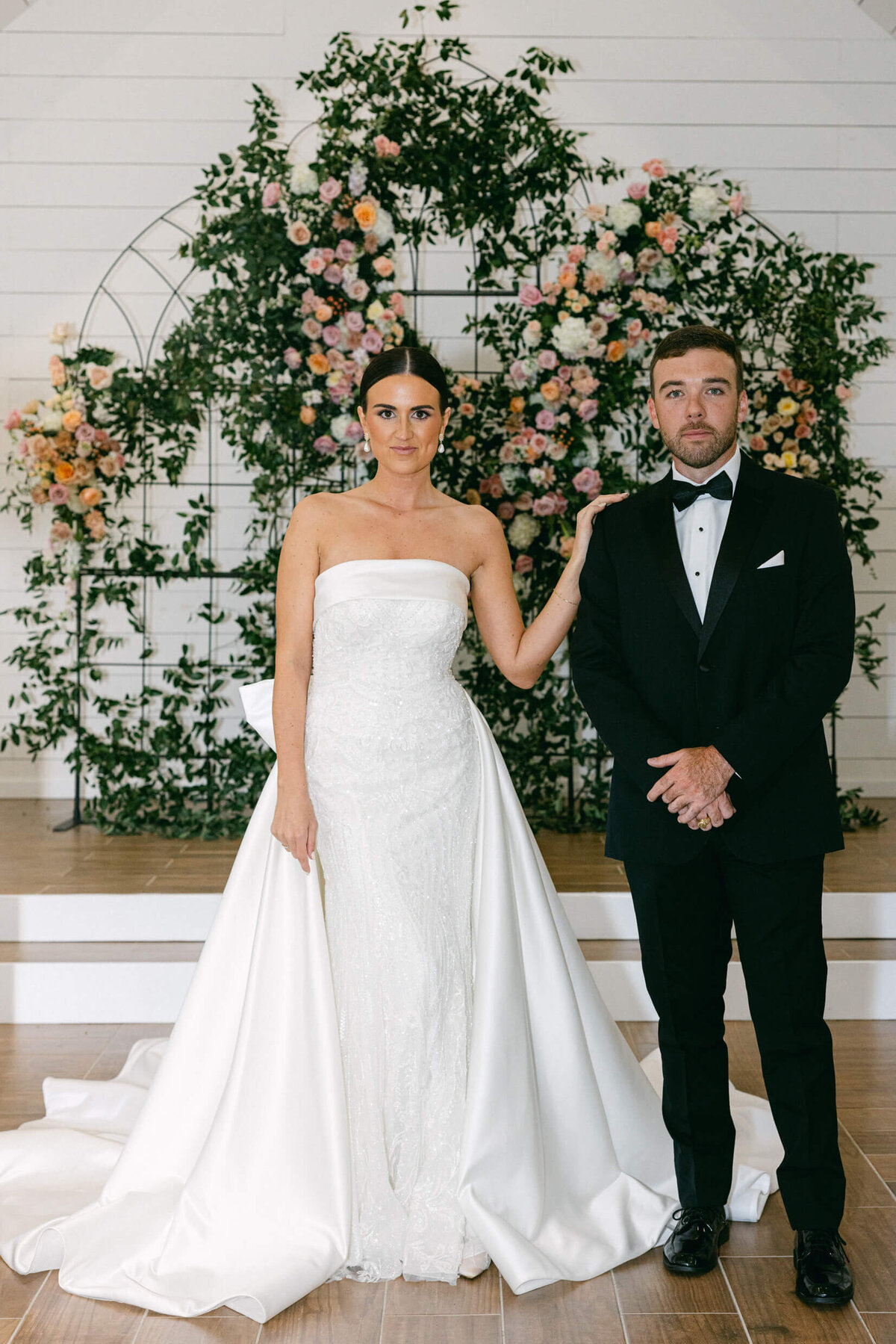 A wedding day photo of the bride and groom posing for a portrait