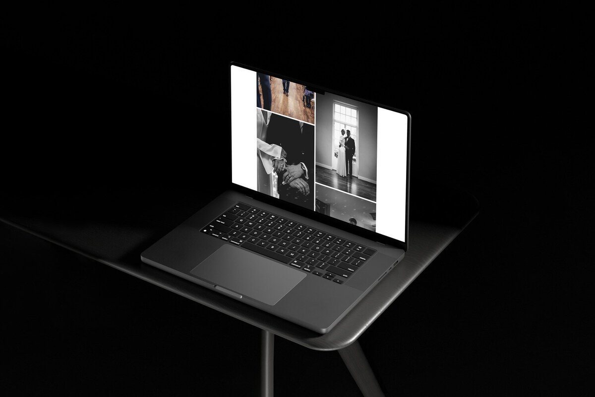 A laptop displaying a gallery of black-and-white wedding photos, including images of a couple holding hands, dancing, and standing together by a window. The laptop is placed on a dark surface, emphasizing the elegance and simplicity of the wedding photography showcased.
