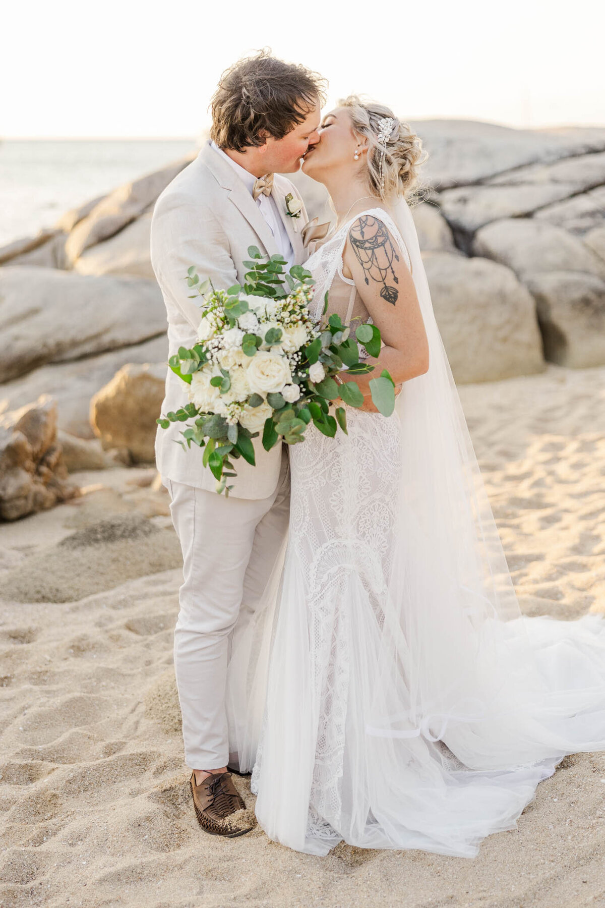 bride and groom kissing during portraits on their whitsunday wedding day by wedding photographer alyce hozly