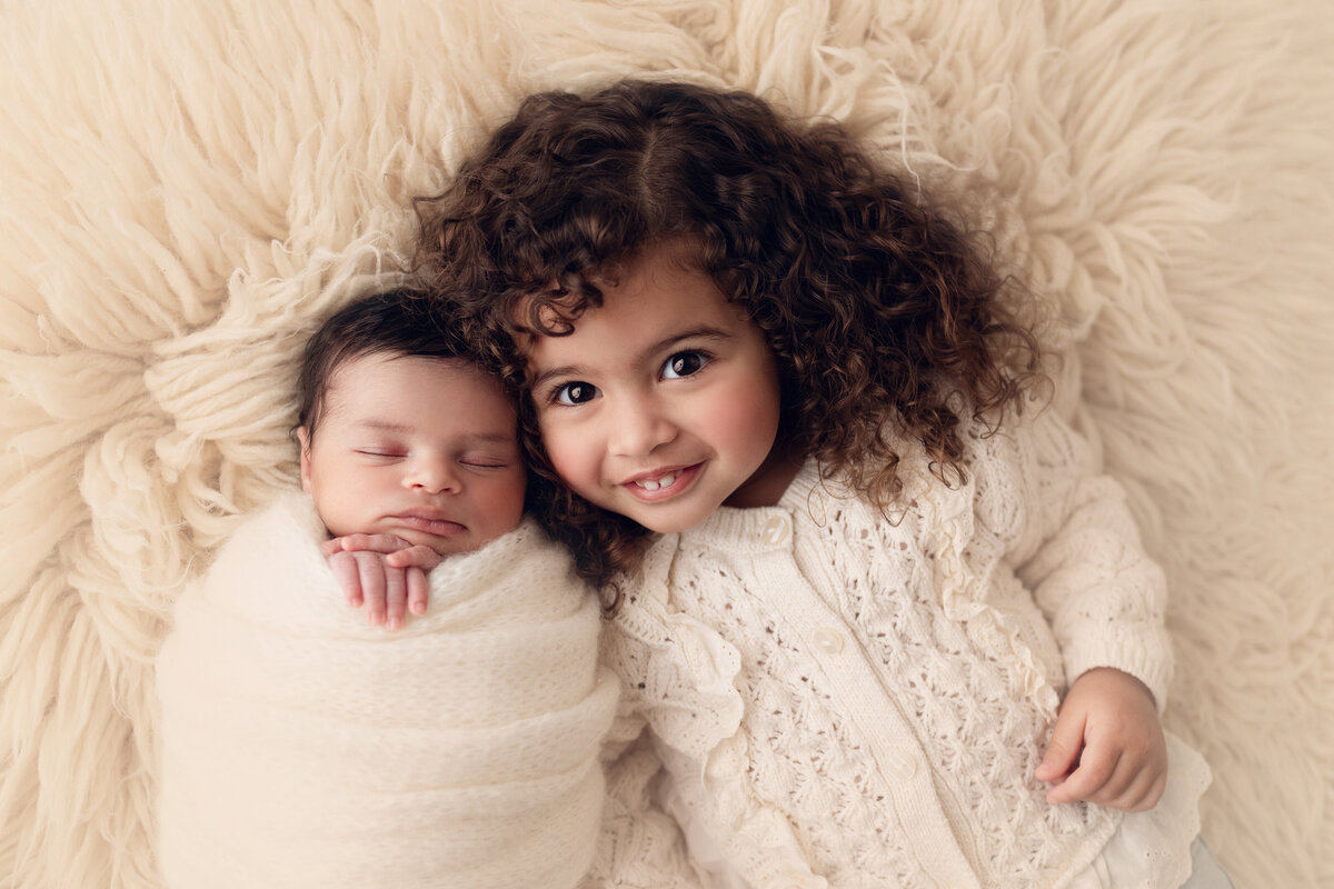 toddler with baby