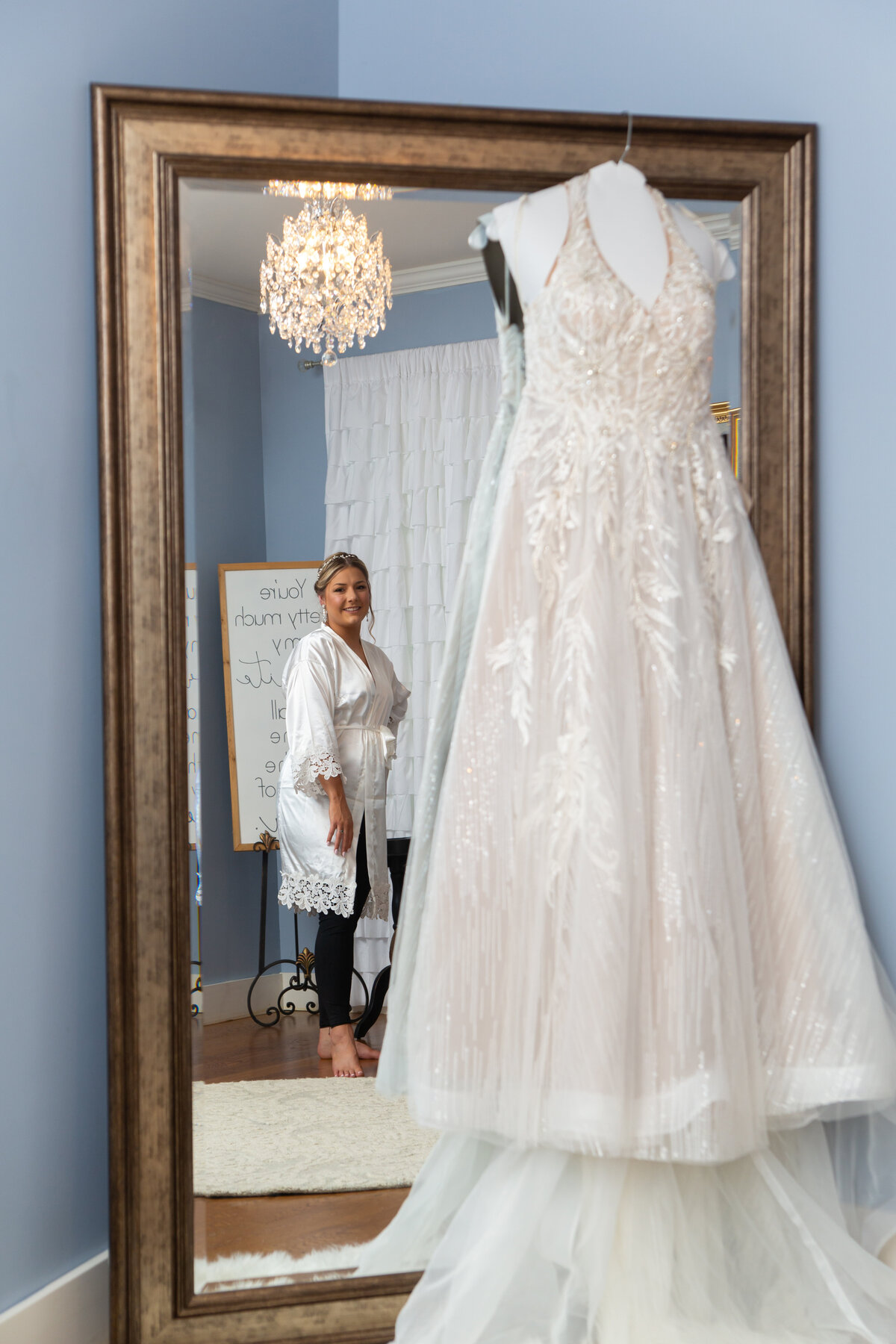 wedding dress hanging on a mirror