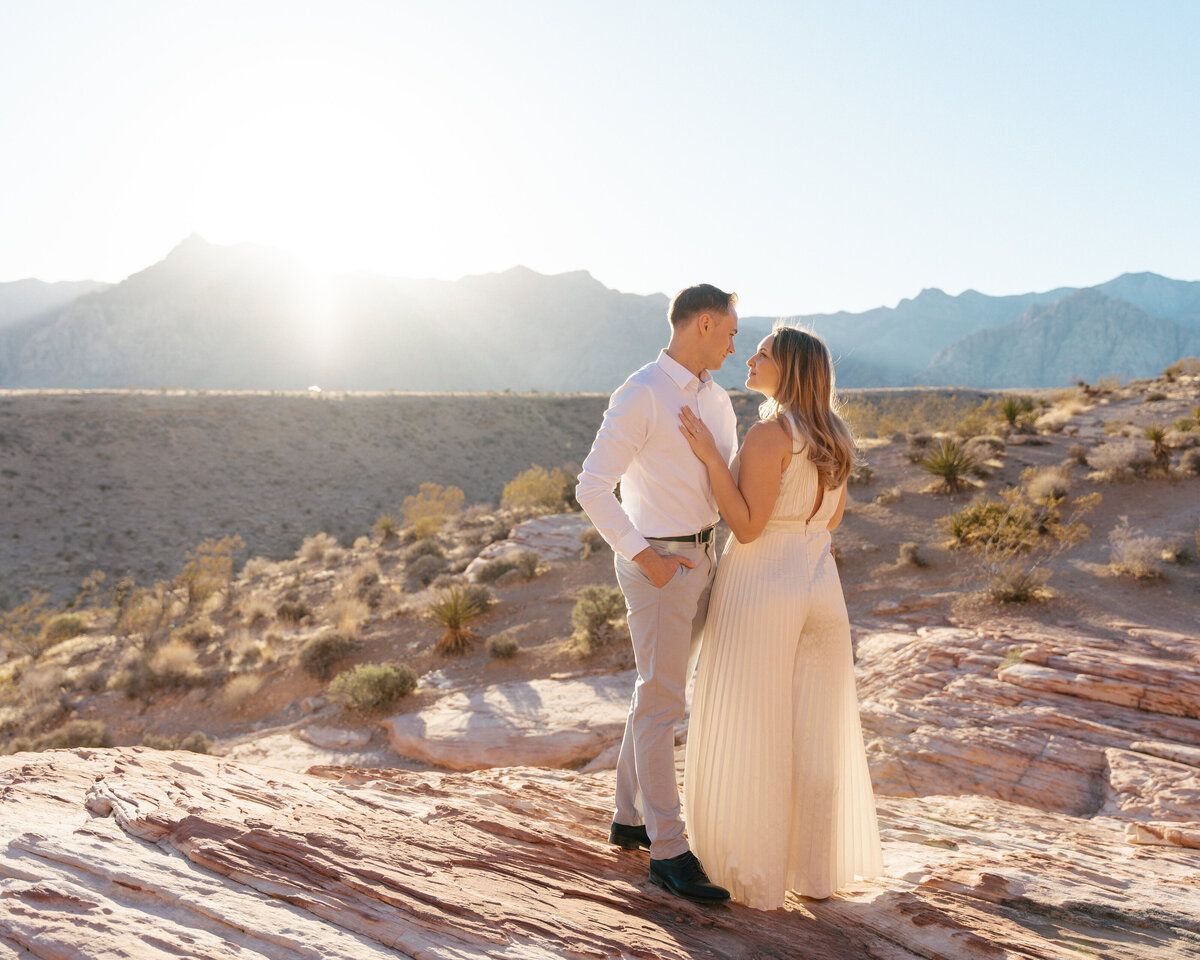 couple looking into each others eyes at sunset in red rock canyon