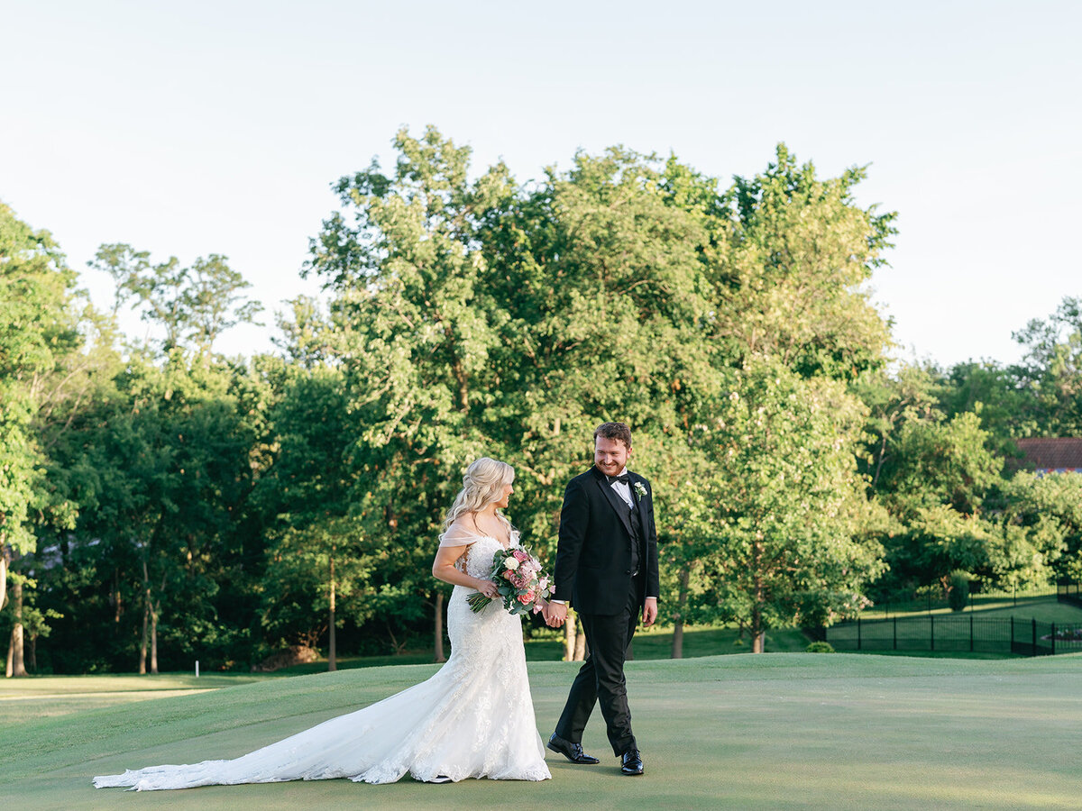 Bride and groom pictures on the golf course at Wedding party pictures at Meadowbrook Country Club in St. Louis