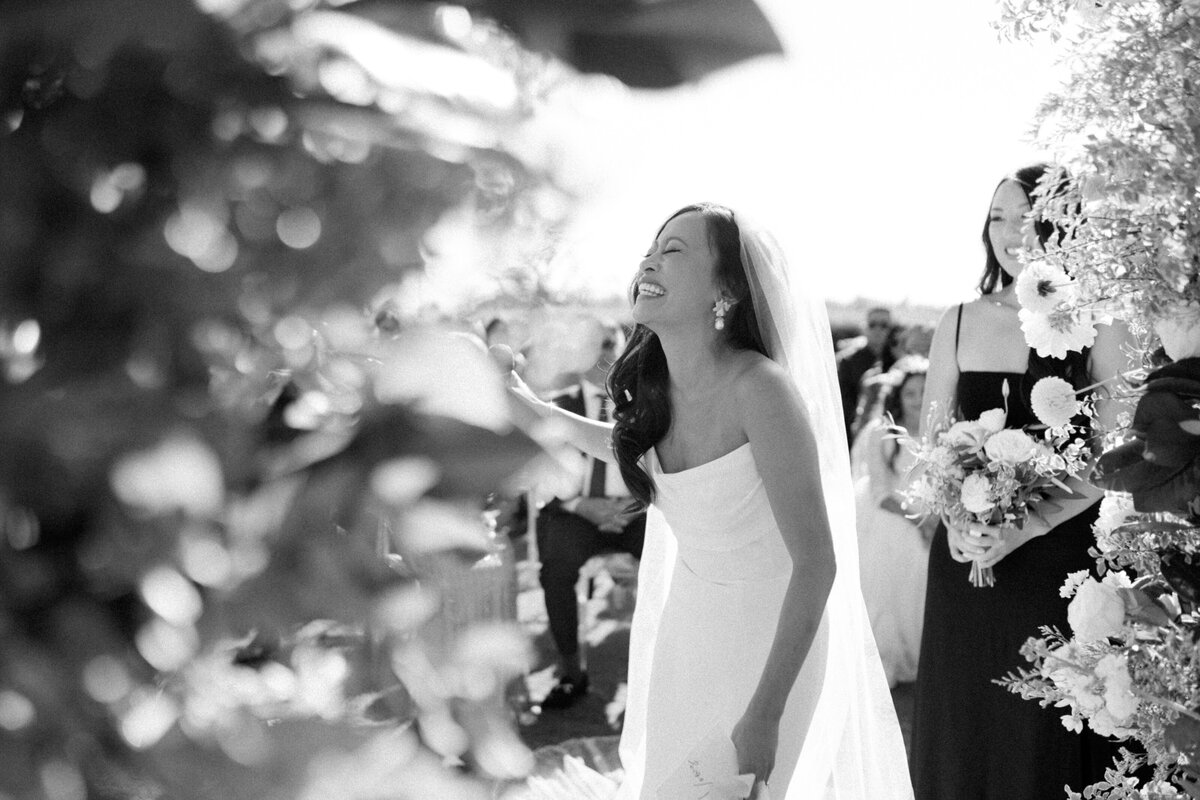 a bride and groom exciting ceremony with huge smiles and movement in image