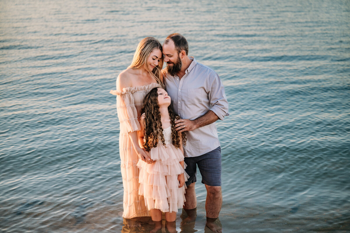 Family enjoys the water during family photos at the coronado beach
