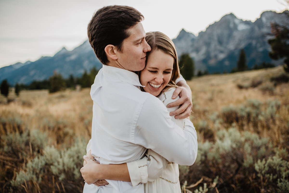 Jackson Hole Photographers capture couple hugging in front of Tetons