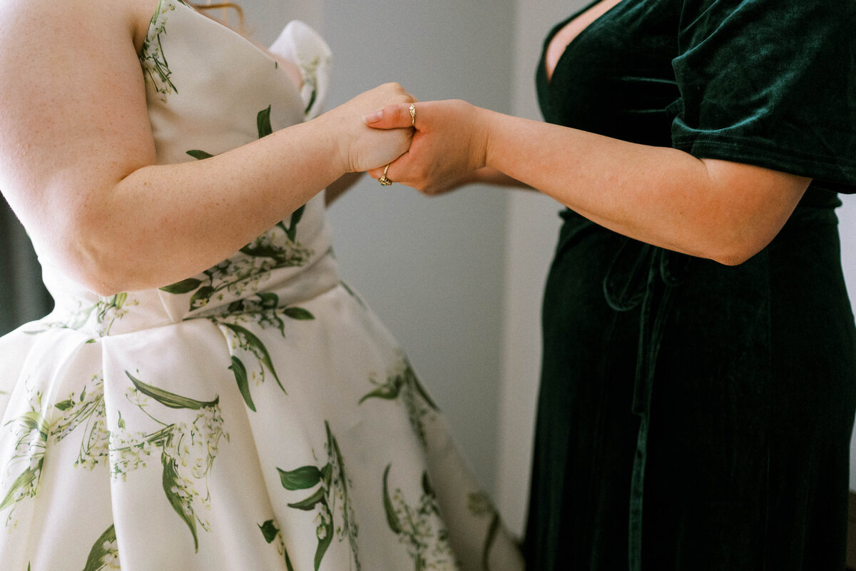 tender-moment-holding-hands-bride