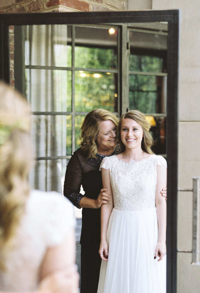 Bride looking at herself in the mirror