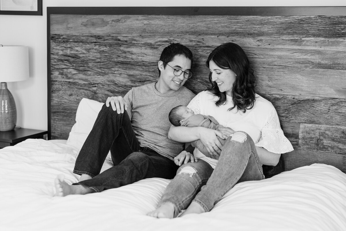 black and white photo of parents holding newborn baby in Santa Monica, CA