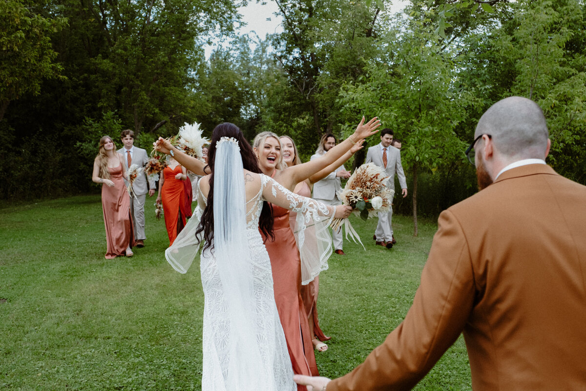 newlyweds-receiving-congratulations-after-their-boho-backyard-ceremony-in-ottawa-1