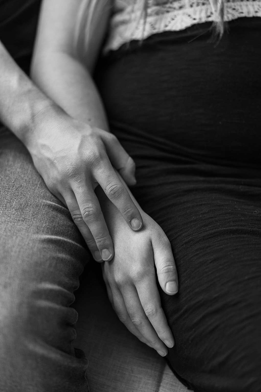 Pregnant couple holding hands