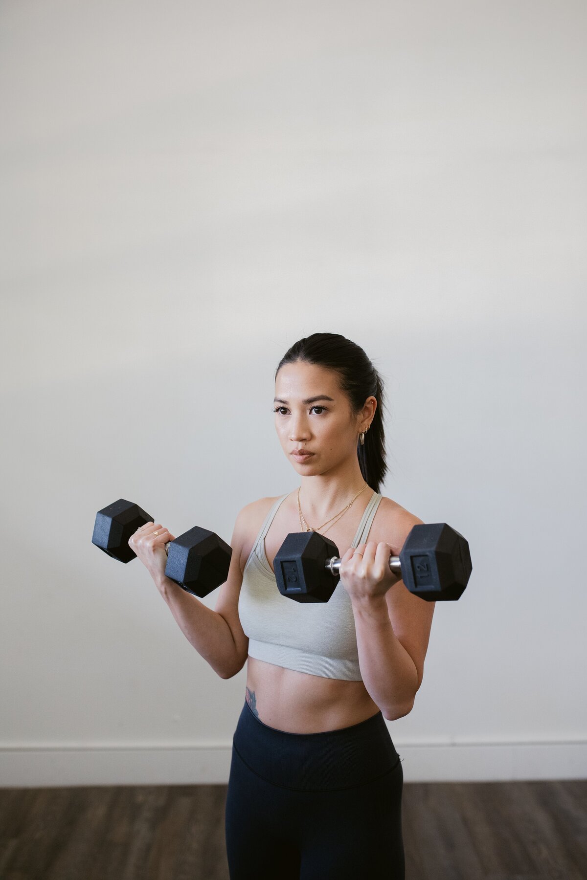personal trainer curling dumbells