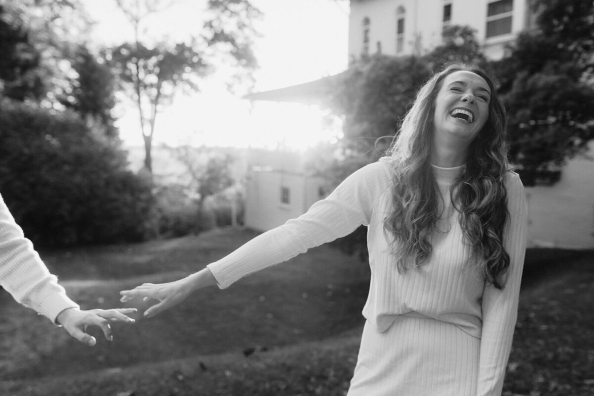 Woman holding arm outstretched at Finger Lakes engagement session