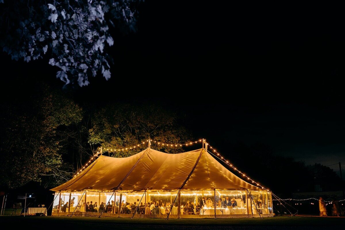 A pole marquee at night showing lots of light coming from within