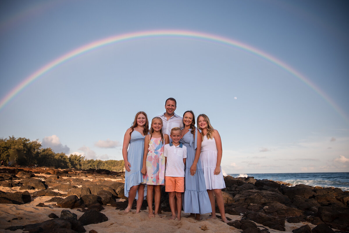 family at shipwreck beach with rainbow