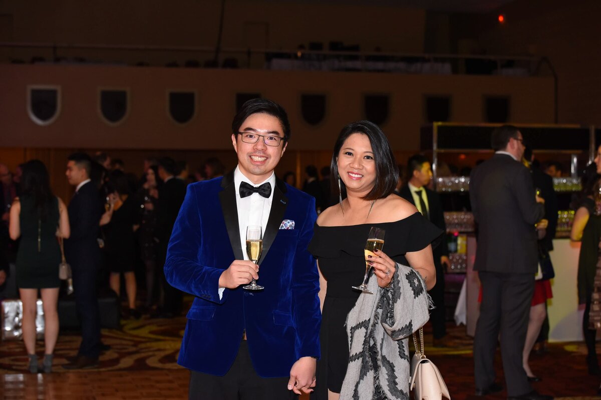 Group of professionals enjoying a gala dinner event in Toronto, showcasing vibrant smiles and evening attire