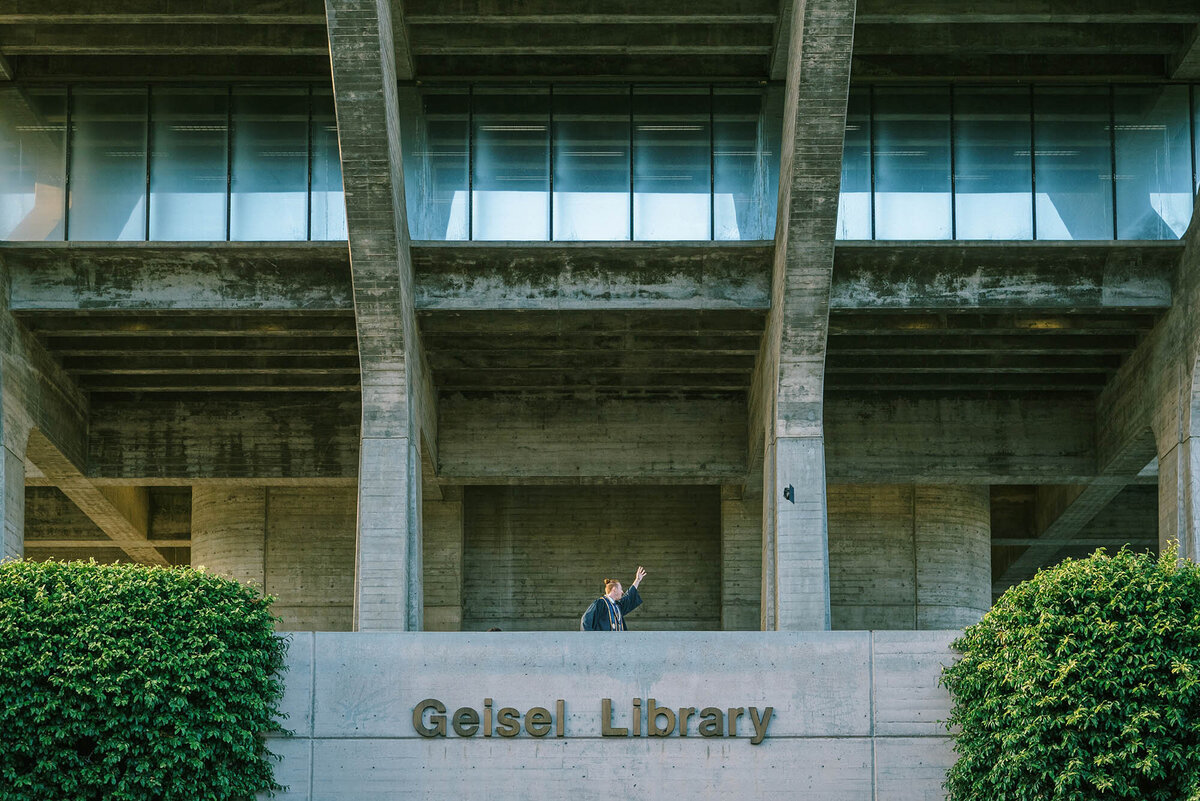UCSD graduate throwing his cap from the Geisel Library
