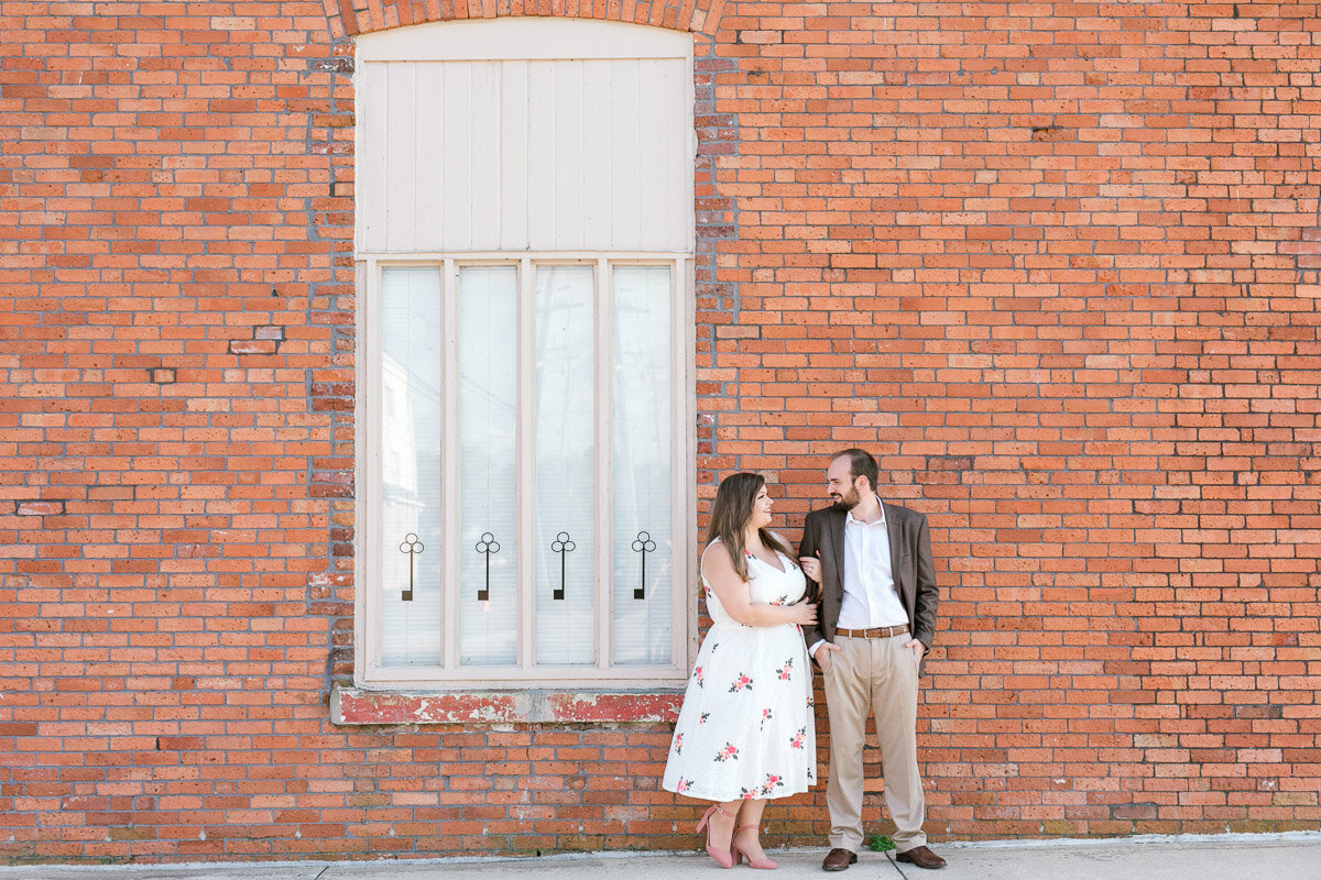 couple against brick wall