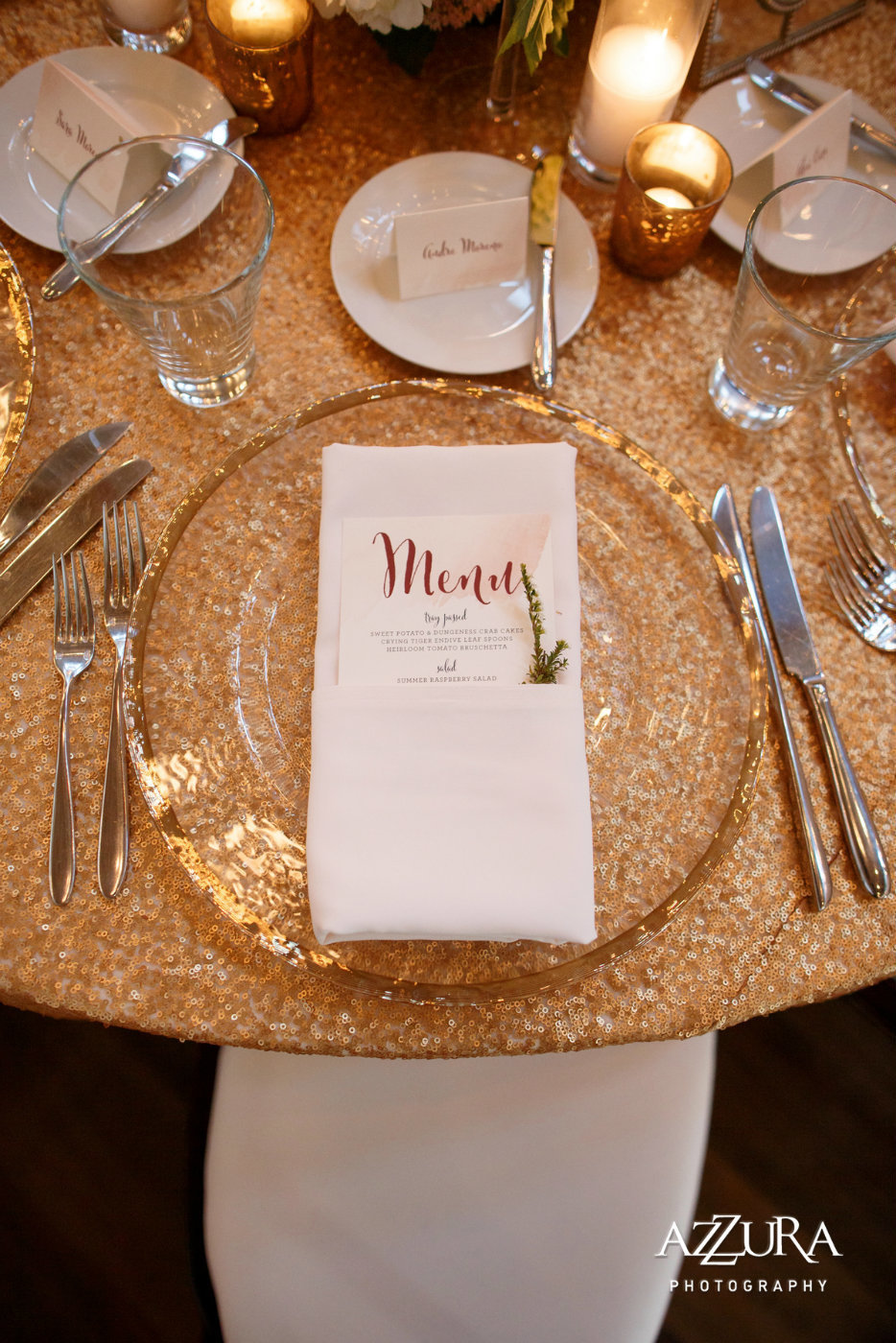 gold rimmed glass charger plate on sequin linen