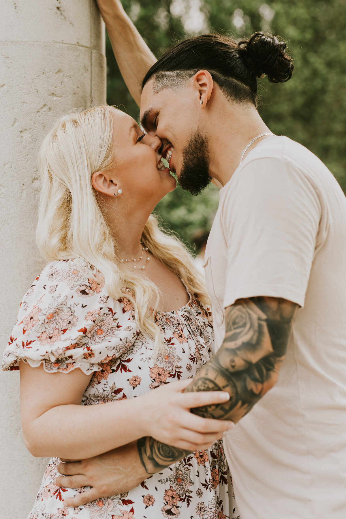 couple posing with a kissing photo from engagement session