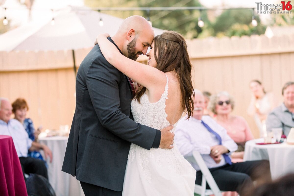 Romantic first dance for newly married couple in a backyard reception