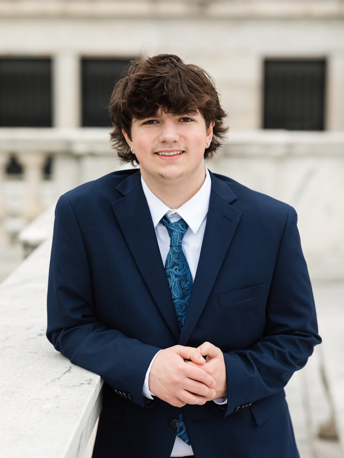 high school senior boy in blue suit posed at Cleveland Museum of Art for portraits