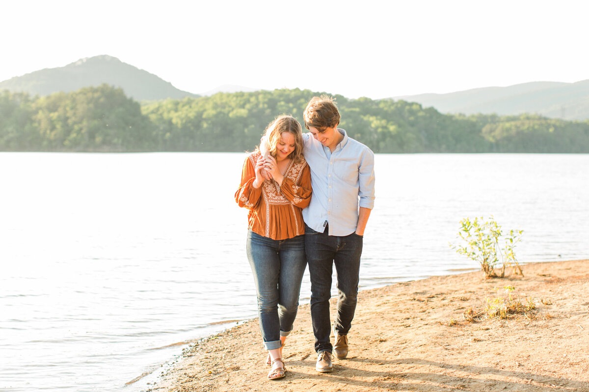 couple walks together near lake