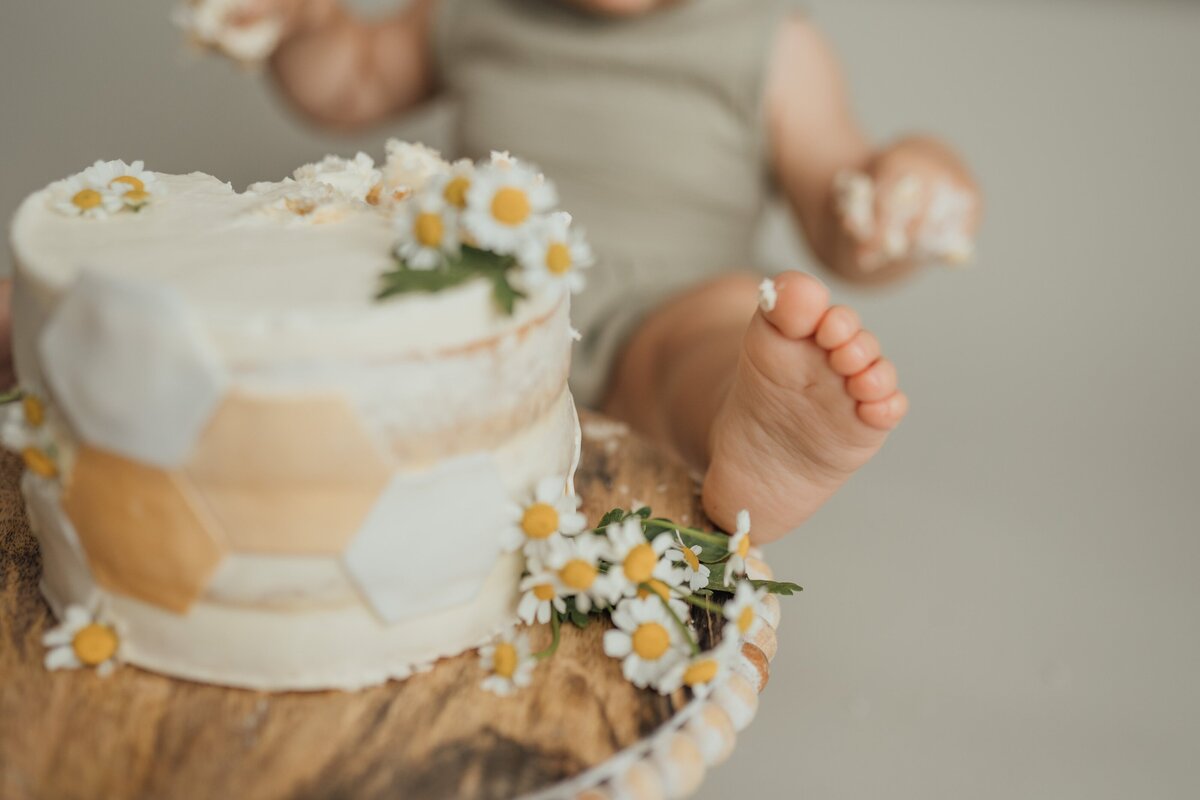 baby foot near cake during cake smash in tampa