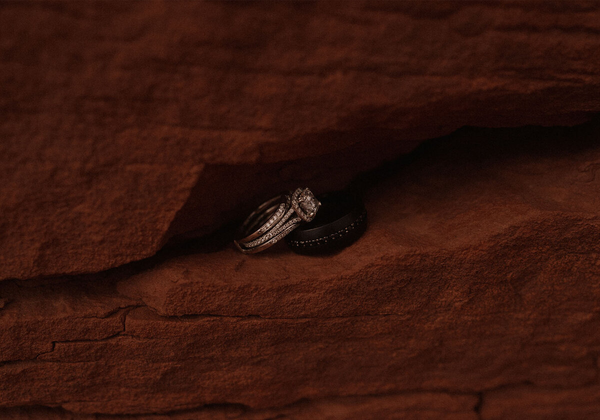 bride's wedding ring sits in a small crevasse in the red, Moab sandstone rock