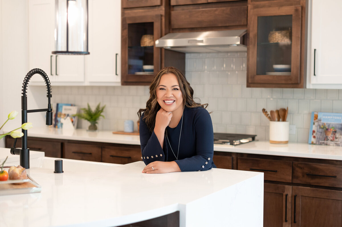 Confident branding photo of Marilly Mendez in modern kitchen office