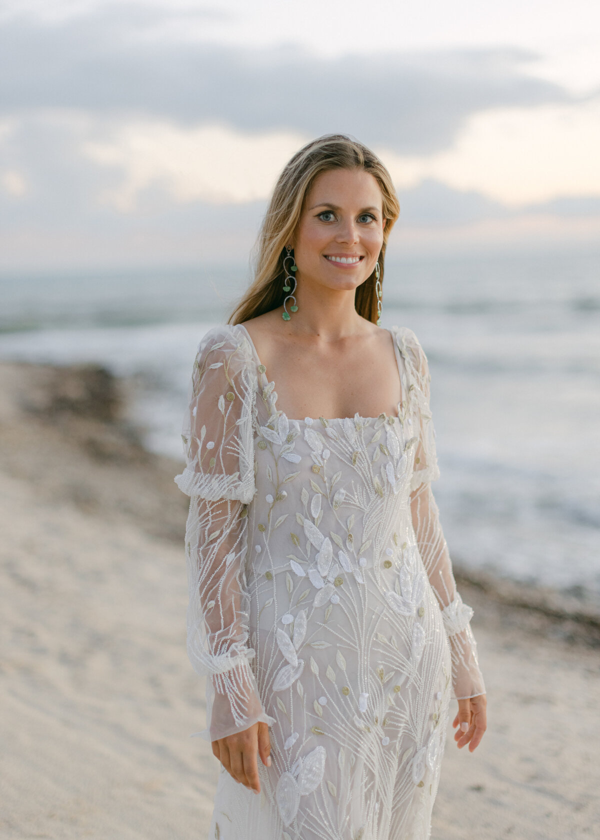 Bride smiling standing on beach