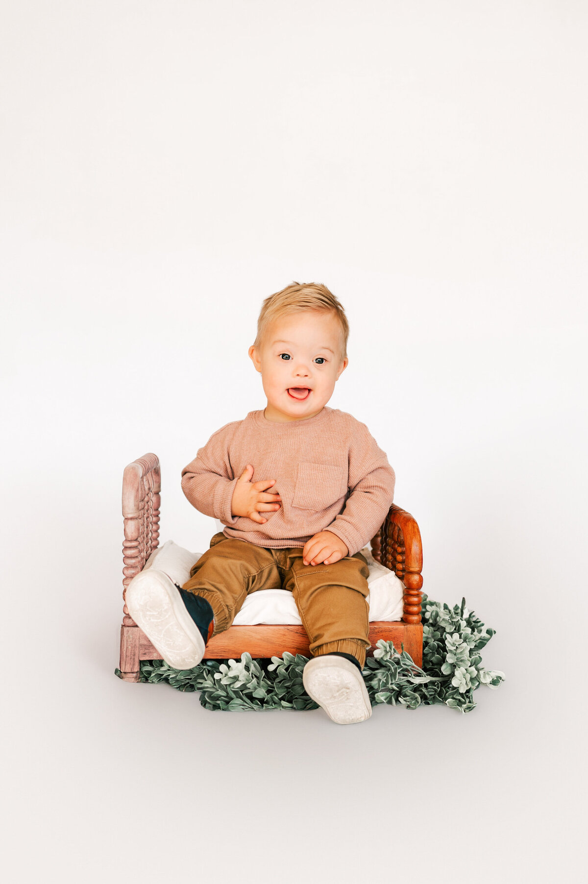 Springfield MO kids photography of toddler boy sitting on wood bed