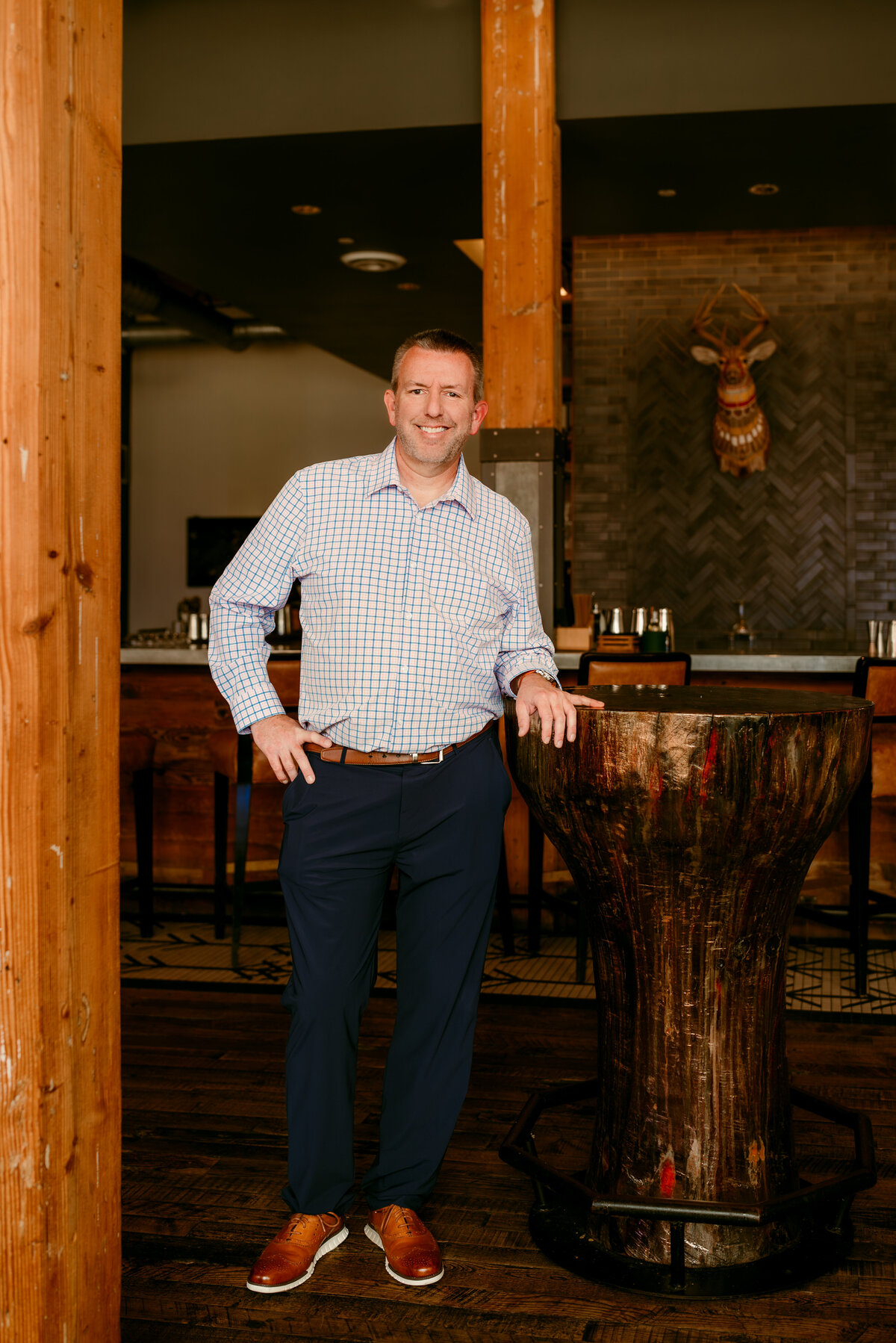 Stylish full-body dating portrait of a man in his 40s dressed in elevated casualwear, captured at The Hewing Hotel in Minneapolis
