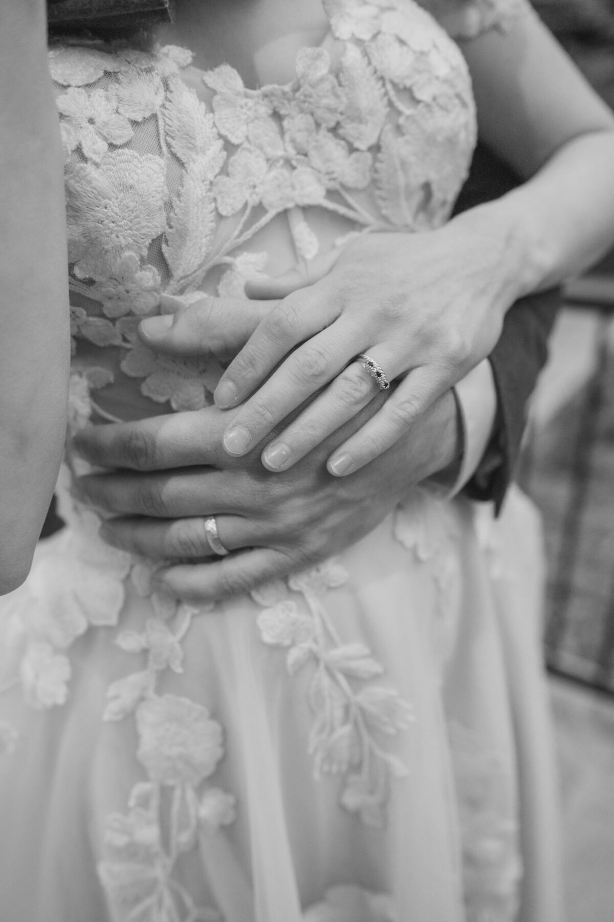 Close up of two hands with wedding bands