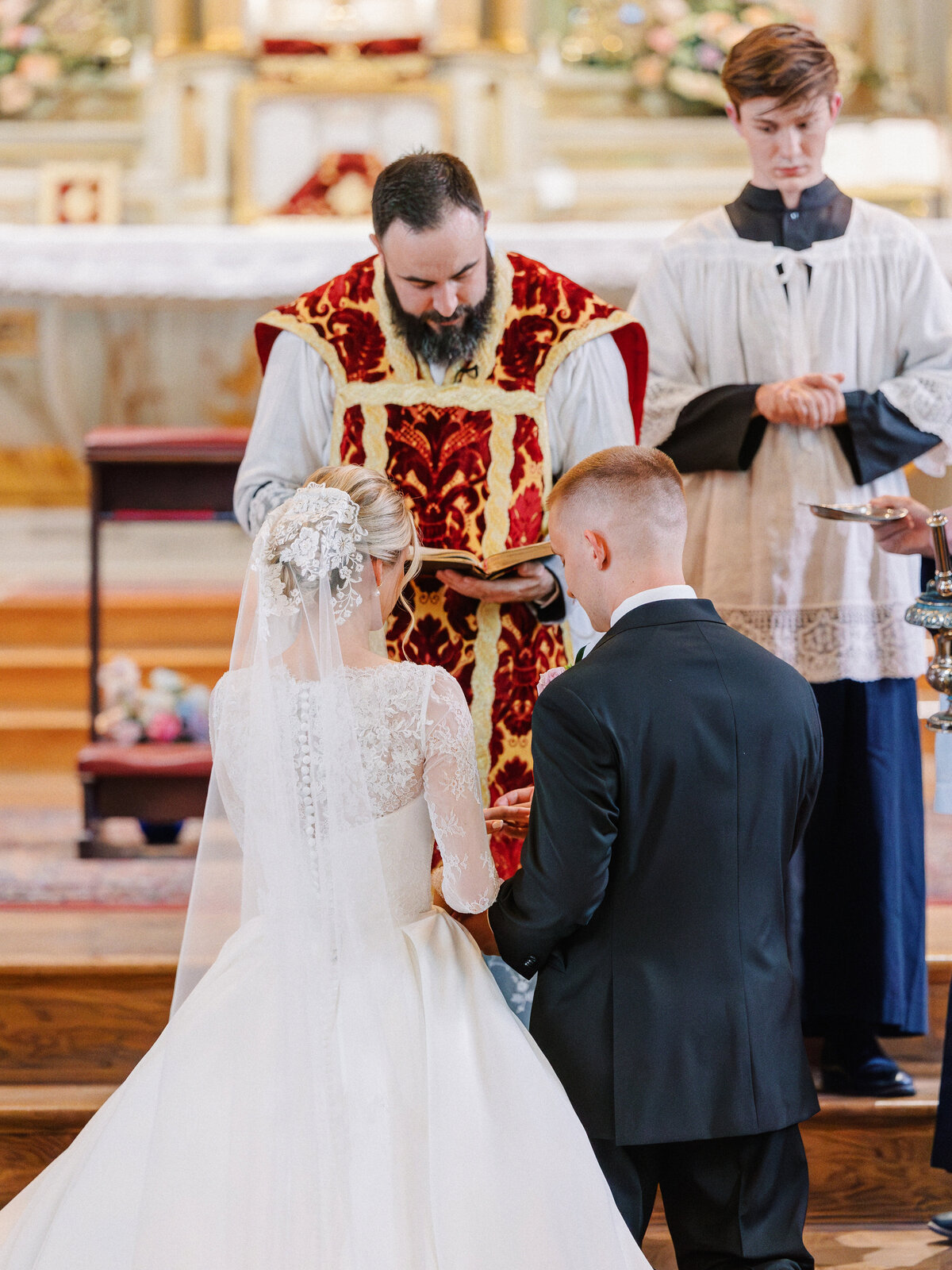 Bride and groom taking Eucharist during traditional Latin Mass at Old St Marys wedding in Cincinnati