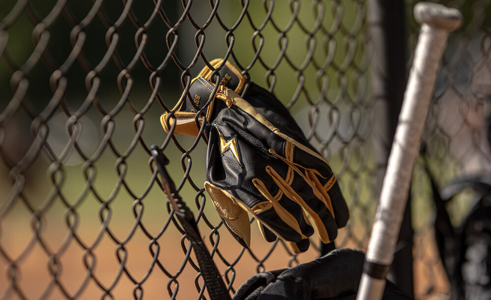 softball-glove-on-fence