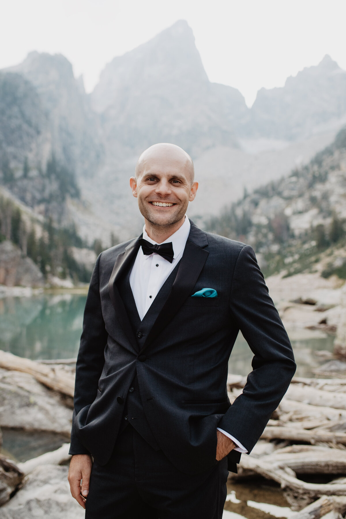 Jackson Hole Photographers capture groom smiling while wearing tuxedo