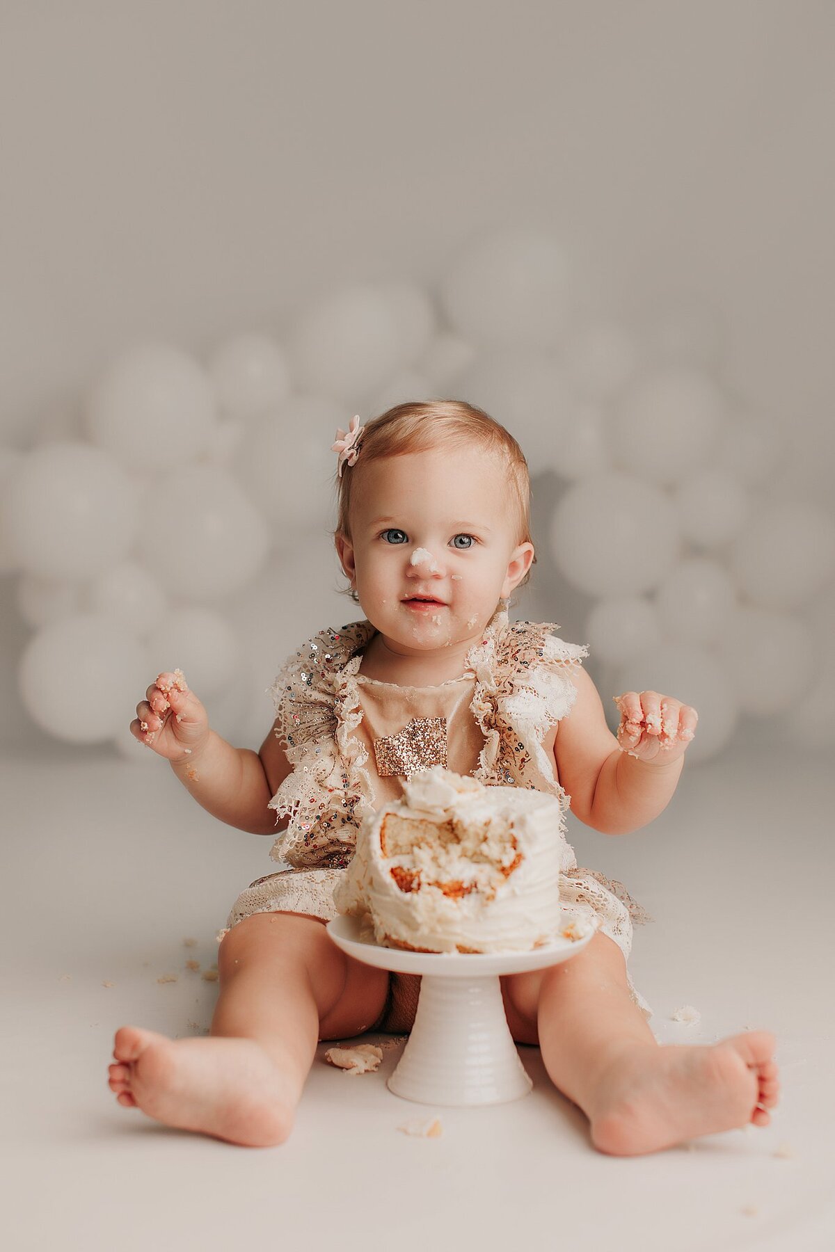  Minimalist cake smash setup with simple white cake and soft colors