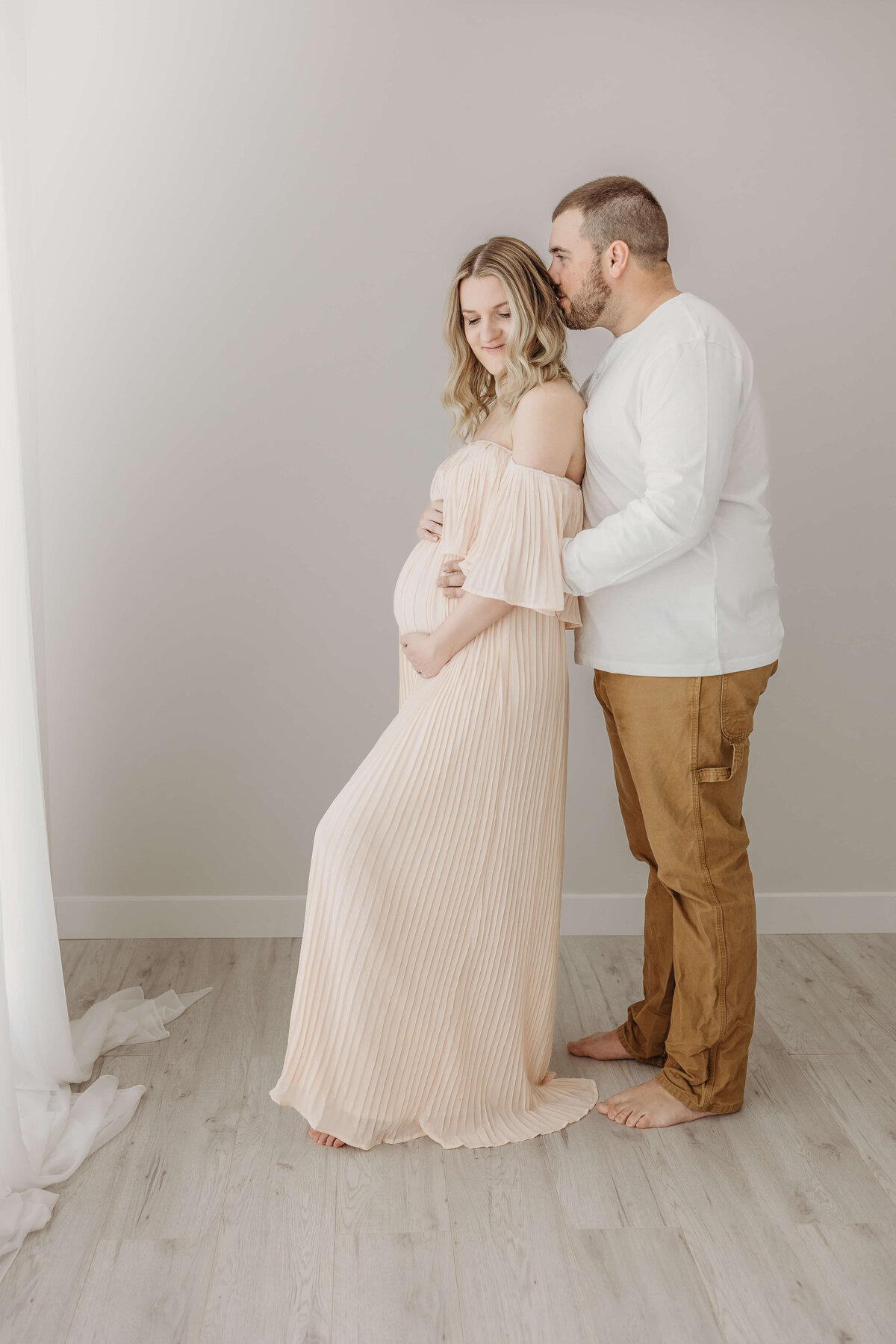 Couple photoshoot for expecting mom and dad in studio