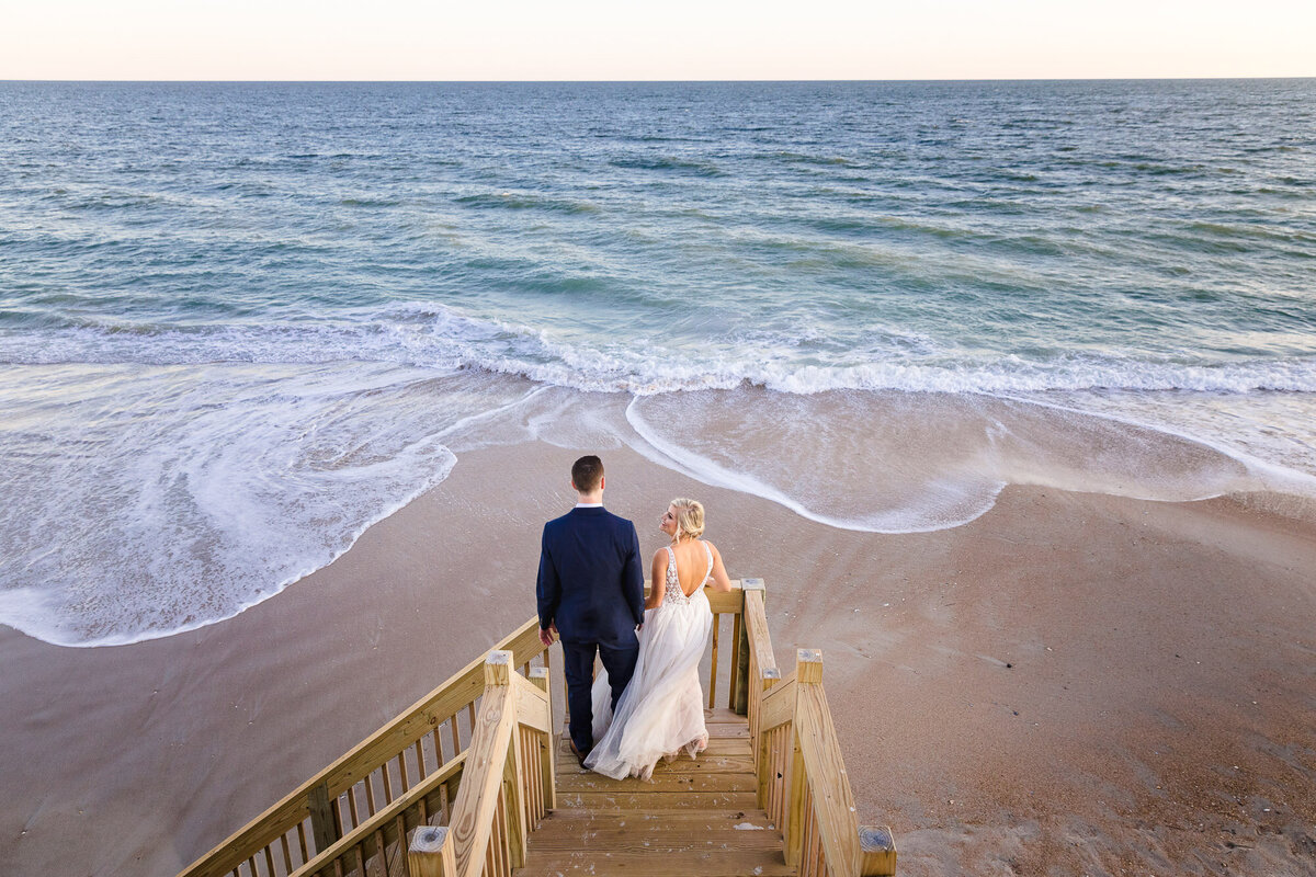 Bride and Groom holding hands and laughing after their wedding 