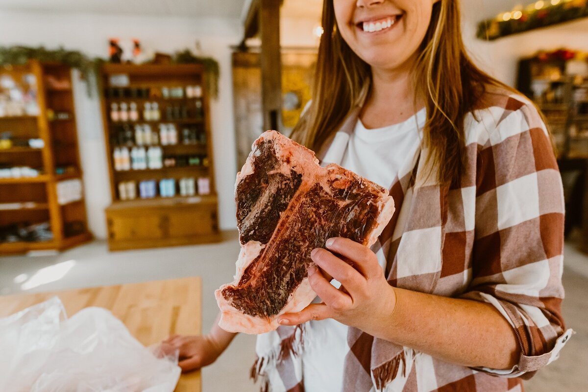 Person holding a piece of steak