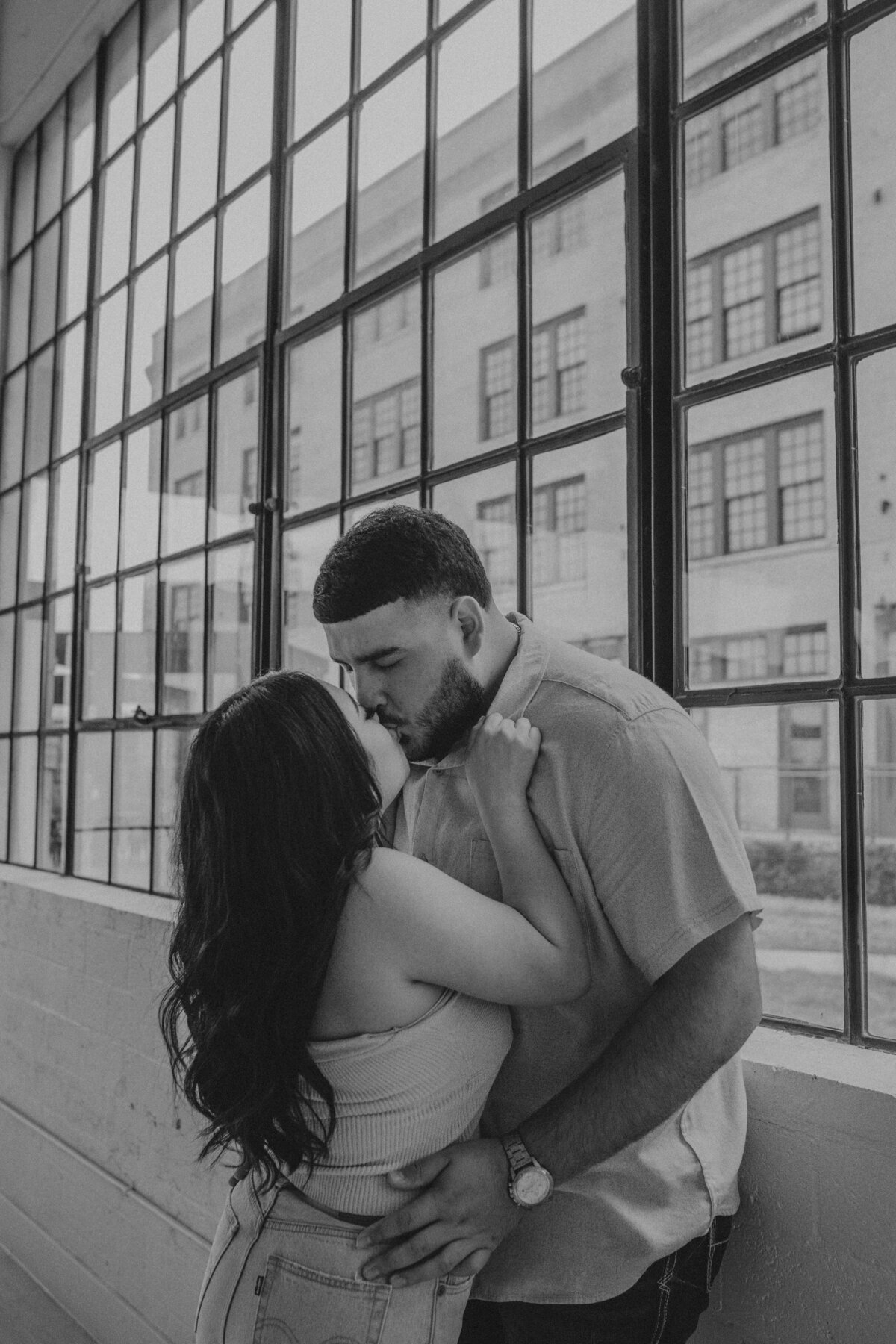 As a wedding photographer documenting an engagement photoshoot near downtown Houston, I was captivated by the studio's loft-like atmosphere, which added an urban edge to the session. Against the backdrop of exposed brick walls and industrial fixtures, the couple's love radiated with authenticity and warmth, resulting in photographs that captured the essence of their modern romance.